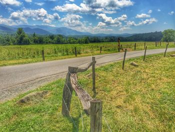 Scenic view of grassy field against cloudy sky