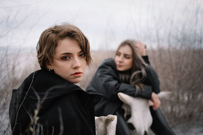 Portrait of a young women looking away on the beach during winter