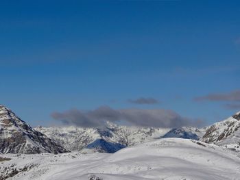 Scenic view of snowcapped mountains against clear blue sky