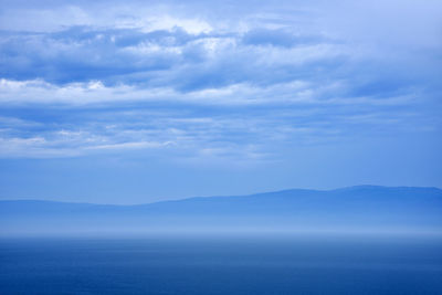 Scenic view of sea against cloudy sky