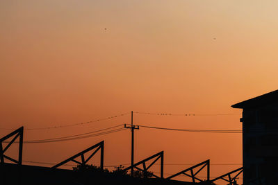 Silhouette of building against sky during sunset