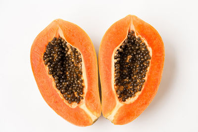 Close-up of orange fruit against white background