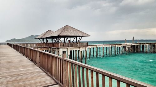 Pier over sea against sky