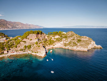 High angle view of rocks on sea shore against sky