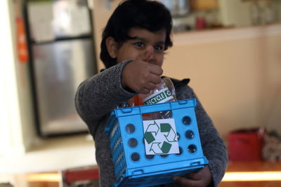 Close-up of boy holding camera