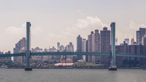 Scenic view of bridge over sea against cloudy sky