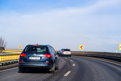 Cars moving on highway against sky