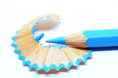 Close-up of colored pencils against white background