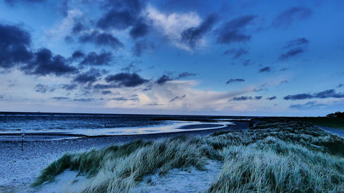 Scenic view of beach against sky during sunset