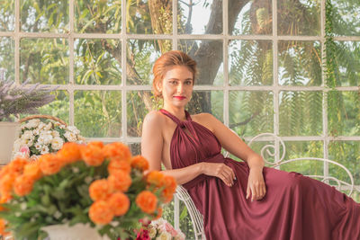 Portrait of young woman with flowers in park
