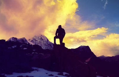 Man standing on mountain during sunset