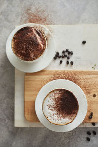 Close-up of coffee cup on cutting board