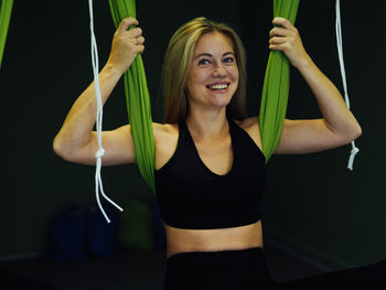 Midsection of woman with arms raised