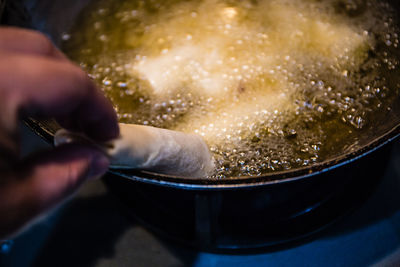 Midsection of man preparing food in kitchen