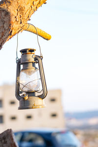 Old-fashioned lantern hanging from tree