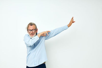 Portrait of smiling senior man against white background