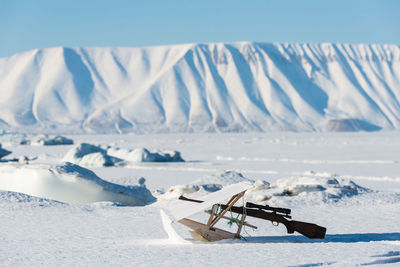 Inuit hunting rifle lying in snow