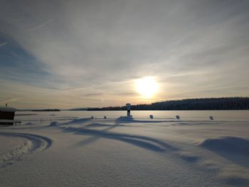 Scenic view of beach against sky during sunset