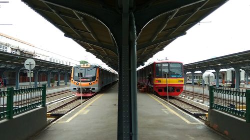 Train at railroad station against sky