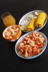 High angle view of chopped fruits in bowl on table