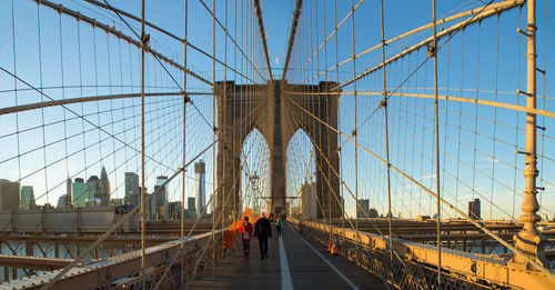 People walking on suspension bridge