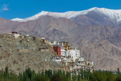 Buildings in town against mountains