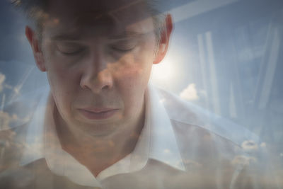 Close-up portrait of young man with eyes closed