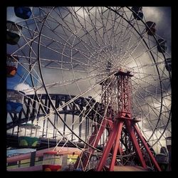 Low angle view of ferris wheel against sky