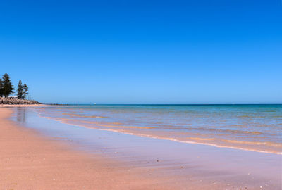 Scenic view of sea against clear blue sky