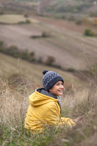 Side view of girl looking away on field