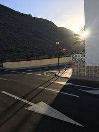 Road by mountains against clear sky