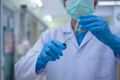 Midsection of person working in kitchen