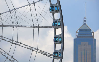 Low angle view of ferris wheel against sky