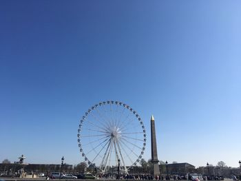 Ferris wheel against clear blue sky