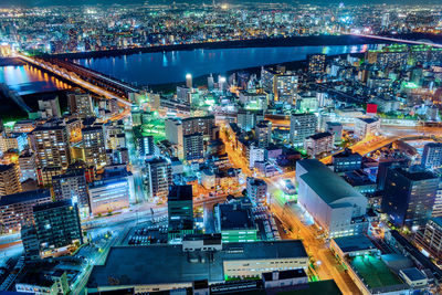 High angle view of city lit up at night