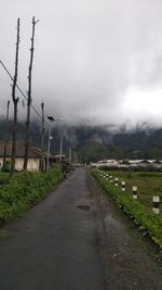 Road passing through landscape against sky