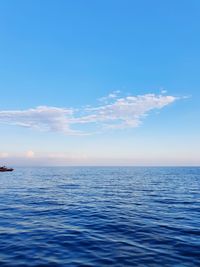 Scenic view of sea against blue sky