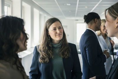 Group of business people talking during conference break