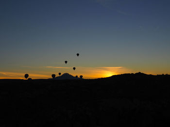 Silhouette of hot air balloon at sunset