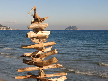 Stack of rock on beach against clear sky