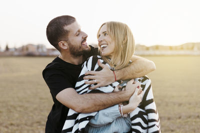 Side view of young man using mobile phone