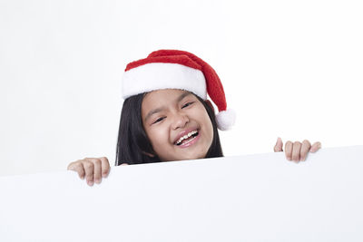 Portrait of a smiling girl over white background