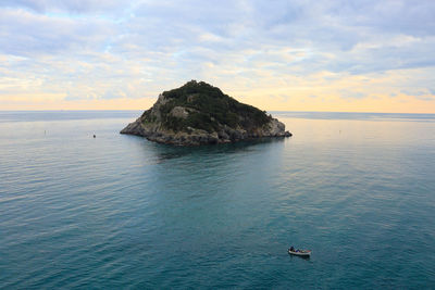 Scenic view of rocks in sea against sky