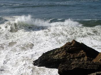 Waves breaking against sea