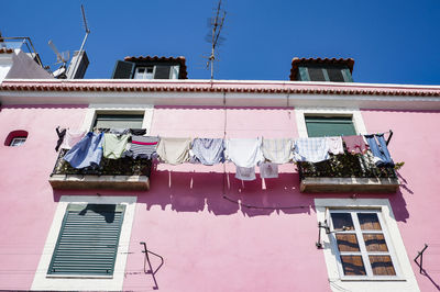 Low angle view of clothes drying at building 