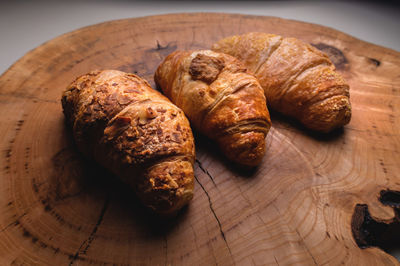 Close-up three freshly baked croissant on a wooden tray. delicious and healthy breakfast