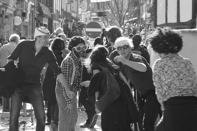 Group of people walking on street in city