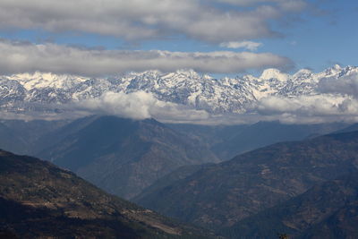 Scenic view of mountains against cloudy sky