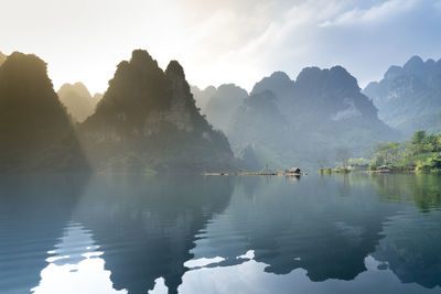 Scenic view of lake against cloudy sky