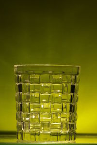 Close-up of empty glass against wall